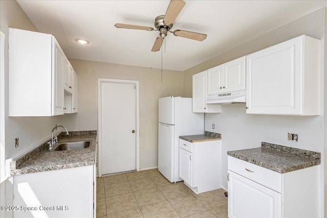 933 Gueld Ave NE, Palm Bay, FL 32905 - kitchen with freestanding refrigerator, under cabinet range hood, a ceiling fan, white cabinetry, and light tile patterned floors