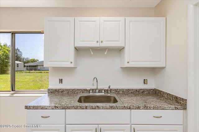 933 Gueld Ave NE, Palm Bay, FL 32905 - kitchen featuring a sink and white cabinetry
