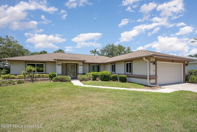 960 Mayflower Ave, Melbourne, FL 32940 - ranch-style home featuring a garage, driveway, stucco siding, and a front lawn