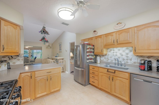 960 Mayflower Ave, Melbourne, FL 32940 - kitchen with appliances with stainless steel finishes, a sink, vaulted ceiling, ceiling fan, and light brown cabinets