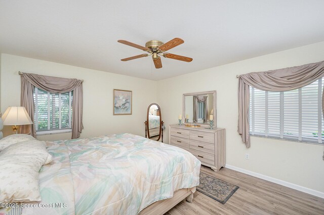 960 Mayflower Ave, Melbourne, FL 32940 - bedroom featuring multiple windows, light wood-style flooring, baseboards, and ceiling fan