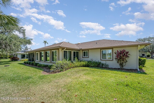 960 Mayflower Ave, Melbourne, FL 32940 - rear view of house featuring a lawn and stucco siding