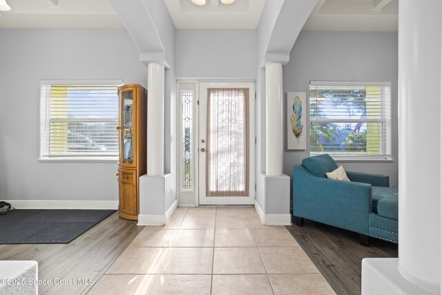 2922 Brandywine Cir, Titusville, FL 32796 - entryway with arched walkways, decorative columns, wood finished floors, and baseboards