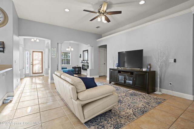 2922 Brandywine Cir, Titusville, FL 32796 - living room with arched walkways, light tile patterned flooring, a ceiling fan, a chandelier, and recessed lighting