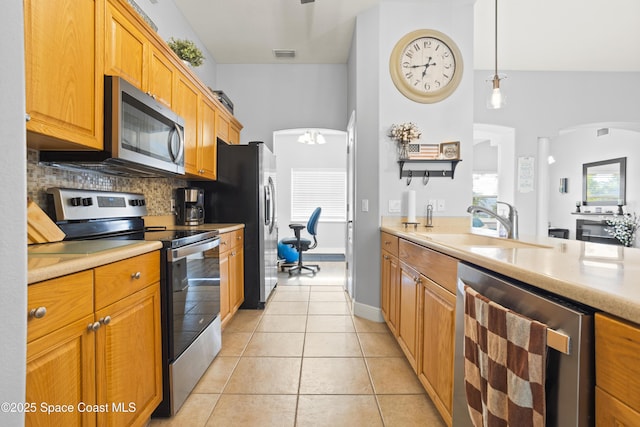 2922 Brandywine Cir, Titusville, FL 32796 - kitchen featuring stainless steel appliances, beverage cooler, tasteful backsplash, a sink, and light countertops