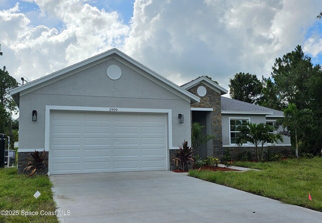 2999 Gaffney Ave SE, Palm Bay, FL 32909 - ranch-style home featuring stone siding, concrete driveway, a garage, and stucco siding