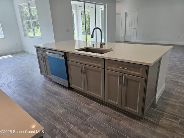 2999 Gaffney Ave SE, Palm Bay, FL 32909 - kitchen with dishwashing machine, gray cabinets, wood tiled floors, and light countertops