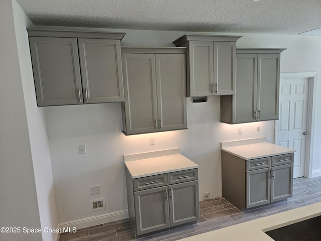 2999 Gaffney Ave SE, Palm Bay, FL 32909 - kitchen featuring gray cabinets, wood finish floors, a textured ceiling, and light countertops