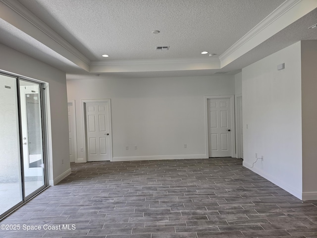 2999 Gaffney Ave SE, Palm Bay, FL 32909 - unfurnished room featuring ornamental molding, dark wood-style flooring, a raised ceiling, a textured ceiling, and recessed lighting
