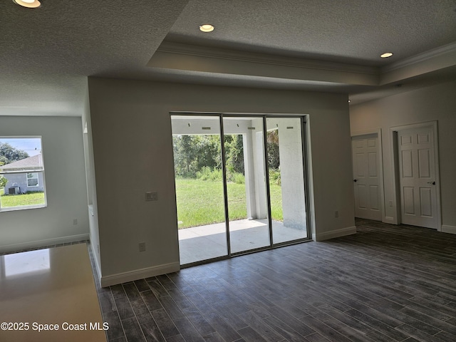 2999 Gaffney Ave SE, Palm Bay, FL 32909 - empty room with a textured ceiling, a tray ceiling, ornamental molding, dark wood-type flooring, and recessed lighting