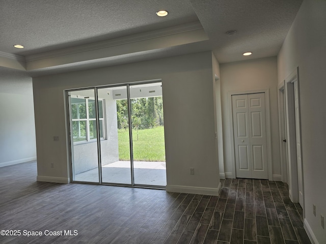 2999 Gaffney Ave SE, Palm Bay, FL 32909 - spare room featuring a textured ceiling, crown molding, dark wood-style flooring, recessed lighting, and a tray ceiling