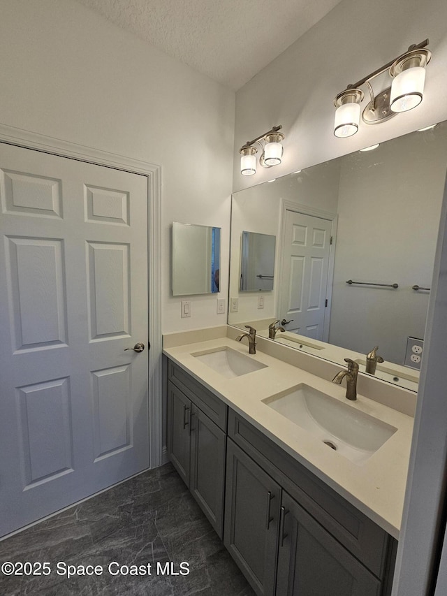2999 Gaffney Ave SE, Palm Bay, FL 32909 - full bath featuring double vanity, a textured ceiling, and marble look tiles