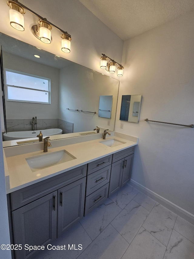 2999 Gaffney Ave SE, Palm Bay, FL 32909 - full bath featuring marble look tiles, a freestanding tub, double vanity, and a textured ceiling