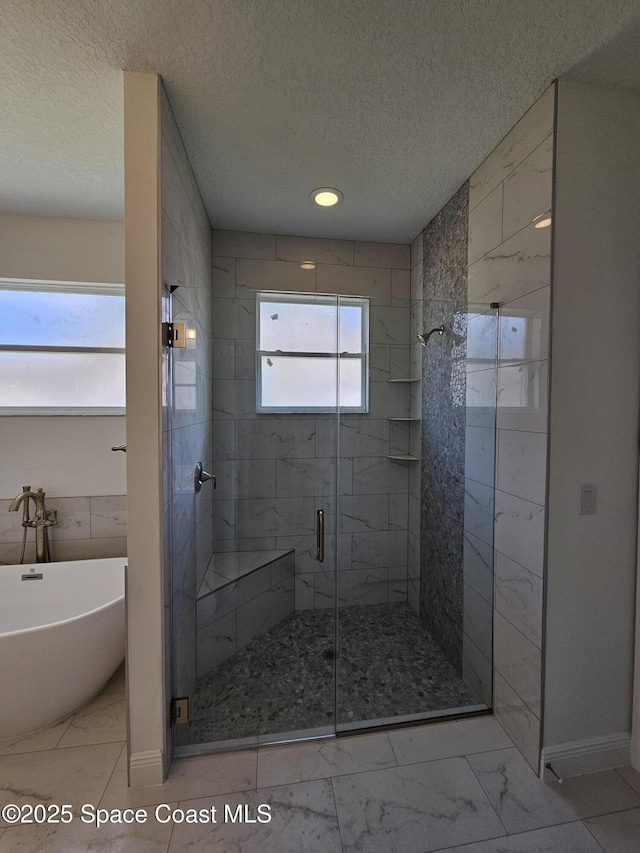 2999 Gaffney Ave SE, Palm Bay, FL 32909 - full bath with a freestanding bath, a stall shower, a textured ceiling, and marble look tile flooring