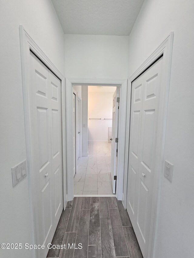 2999 Gaffney Ave SE, Palm Bay, FL 32909 - hallway featuring dark marble finish floors and a textured ceiling