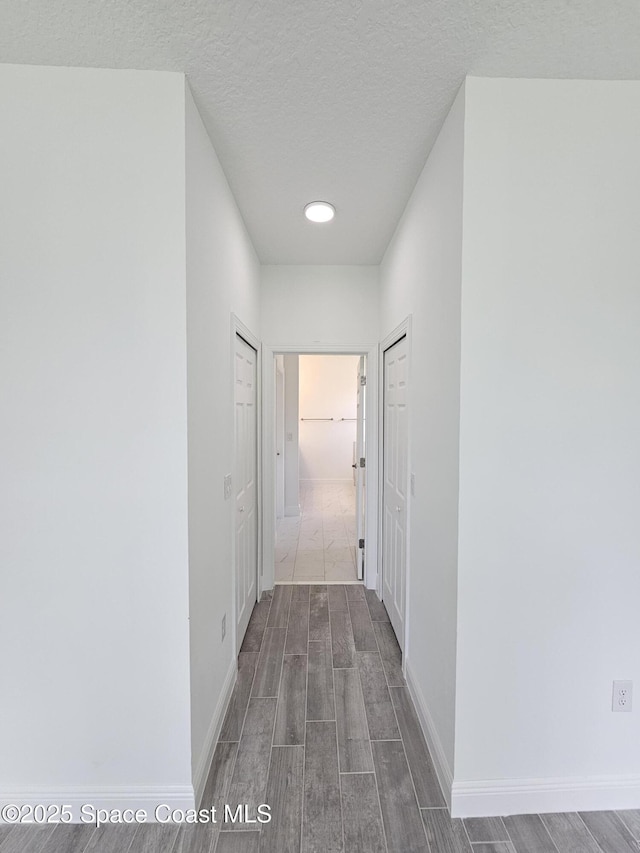 2999 Gaffney Ave SE, Palm Bay, FL 32909 - hall with wood finished floors and a textured ceiling