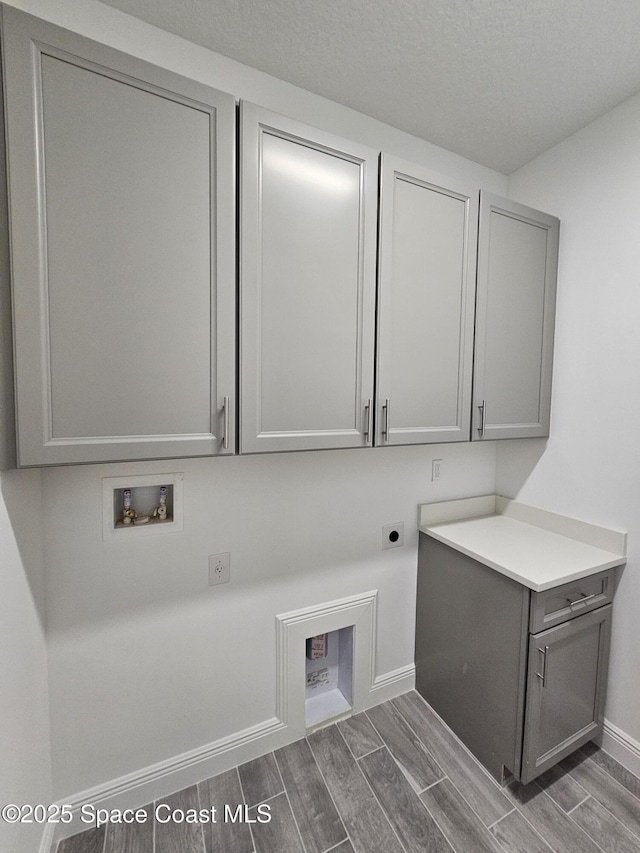 2999 Gaffney Ave SE, Palm Bay, FL 32909 - washroom with cabinet space, electric dryer hookup, washer hookup, and wood finish floors