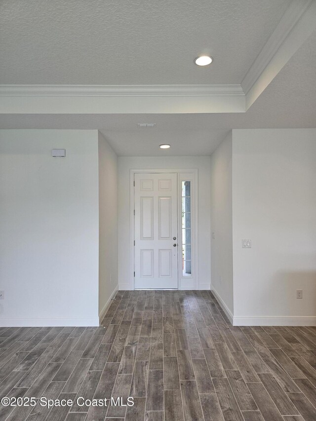 2999 Gaffney Ave SE, Palm Bay, FL 32909 - foyer featuring dark wood-style floors, ornamental molding, recessed lighting, and a textured ceiling