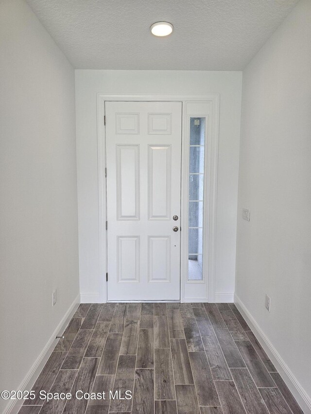 2999 Gaffney Ave SE, Palm Bay, FL 32909 - foyer entrance with dark wood finished floors, a textured ceiling, and recessed lighting