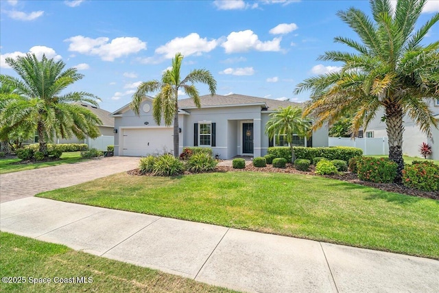 4570 Hebron Dr, Merritt Island, FL 32953 - view of front of property with decorative driveway, stucco siding, and a garage