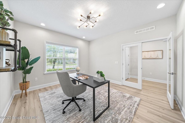4570 Hebron Dr, Merritt Island, FL 32953 - office area with french doors, light wood-style flooring, baseboards, a textured ceiling, and recessed lighting