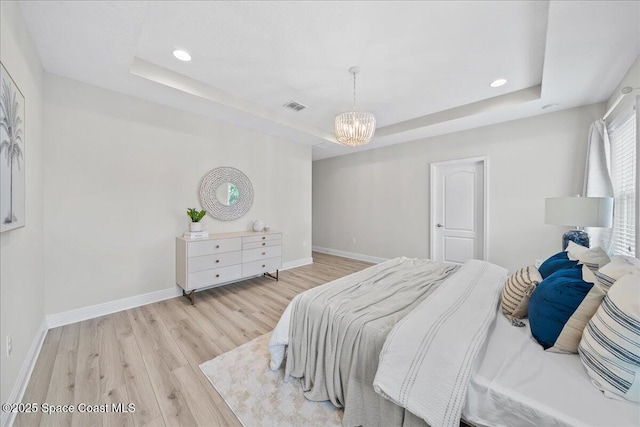 4570 Hebron Dr, Merritt Island, FL 32953 - bedroom with a raised ceiling, light wood-type flooring, a chandelier, baseboards, and recessed lighting