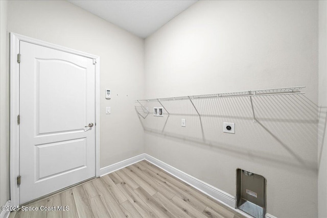 4570 Hebron Dr, Merritt Island, FL 32953 - washroom with hookup for an electric dryer, baseboards, and light wood-style floors