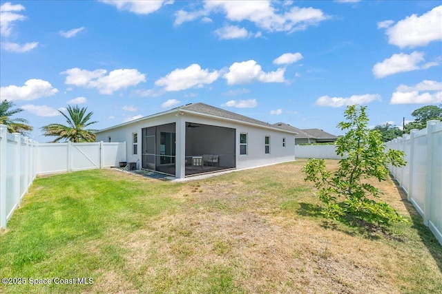 4570 Hebron Dr, Merritt Island, FL 32953 - back of property featuring a sunroom, a gate, and stucco siding