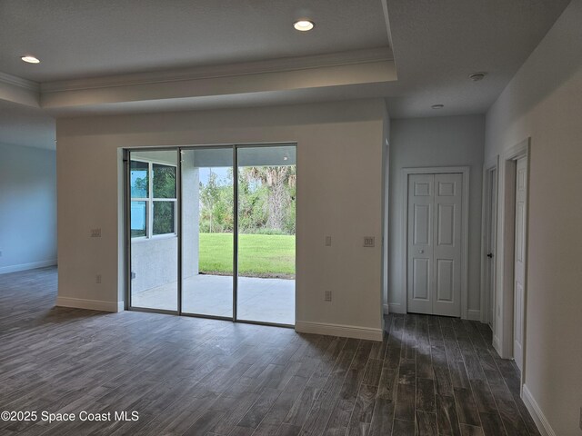 431 Falls Church St SW, Palm Bay, FL 32908 - unfurnished room featuring dark wood finished floors, ornamental molding, a raised ceiling, recessed lighting, and a smoke detector