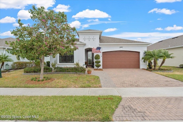 2889 Millennium Cir, Melbourne, FL 32940 - view of front of property with decorative driveway, an attached garage, stucco siding, and a front lawn
