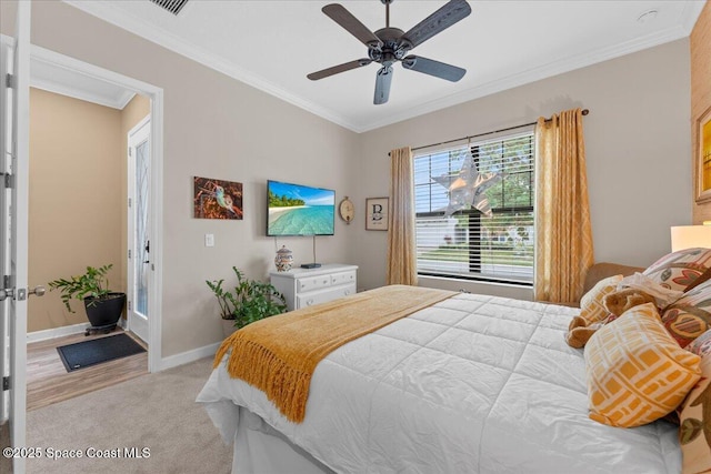 2889 Millennium Cir, Melbourne, FL 32940 - bedroom with ornamental molding, light colored carpet, a ceiling fan, and baseboards