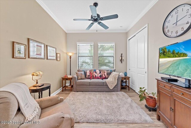 2889 Millennium Cir, Melbourne, FL 32940 - living room with ornamental molding, light wood-style flooring, a ceiling fan, and baseboards