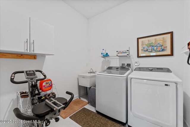 2889 Millennium Cir, Melbourne, FL 32940 - laundry room featuring cabinet space and separate washer and dryer