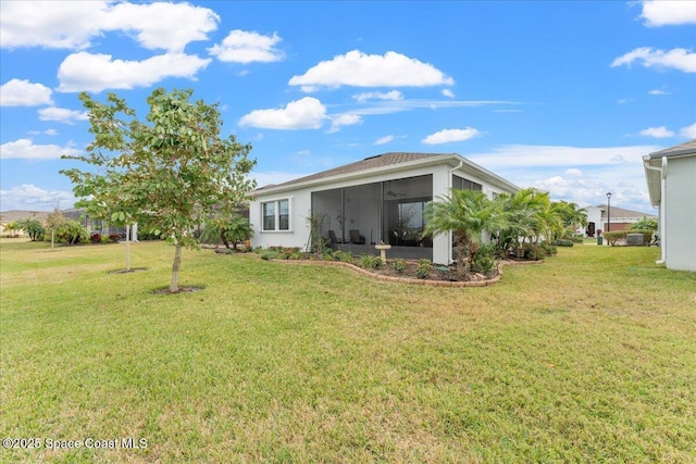 2889 Millennium Cir, Melbourne, FL 32940 - rear view of house with a lawn and a sunroom