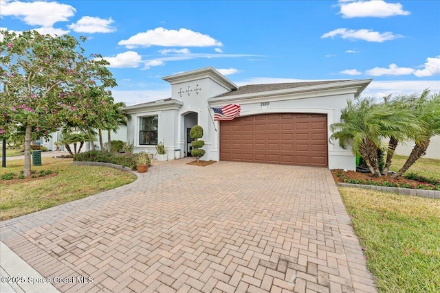 2889 Millennium Cir, Melbourne, FL 32940 - view of front of house with decorative driveway, a garage, stucco siding, and a front yard