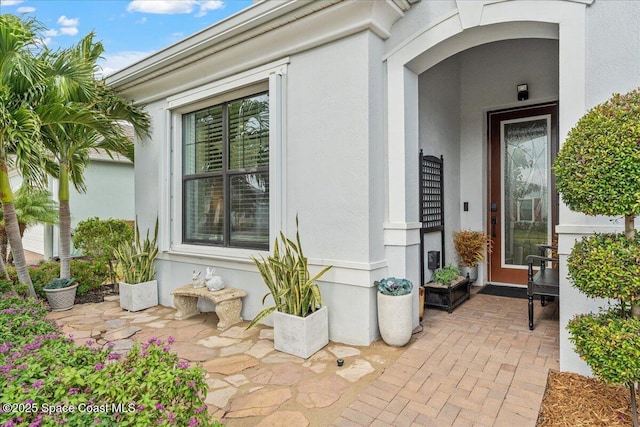 2889 Millennium Cir, Melbourne, FL 32940 - doorway to property featuring stucco siding