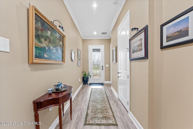 2889 Millennium Cir, Melbourne, FL 32940 - entryway featuring ornamental molding, wood finished floors, and baseboards