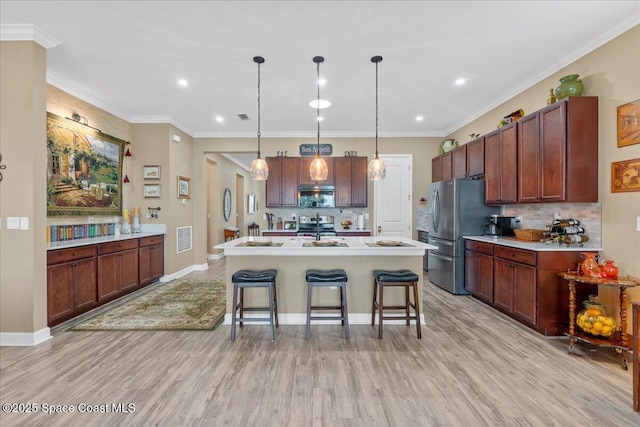 2889 Millennium Cir, Melbourne, FL 32940 - kitchen featuring stainless steel appliances, light wood-type flooring, a breakfast bar, decorative backsplash, and recessed lighting