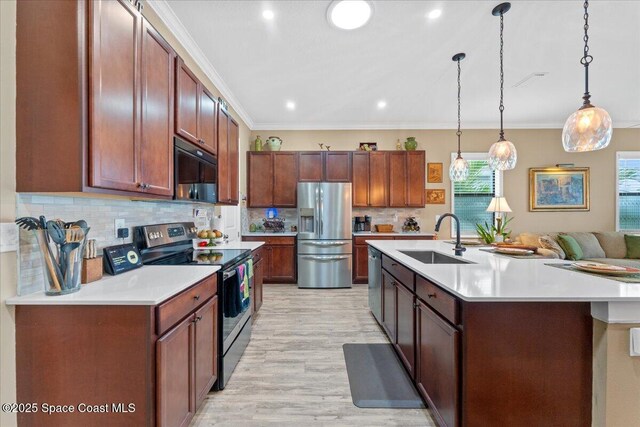2889 Millennium Cir, Melbourne, FL 32940 - kitchen with appliances with stainless steel finishes, a sink, light countertops, light wood-style flooring, and ornamental molding