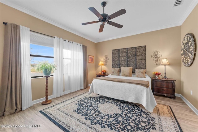 2889 Millennium Cir, Melbourne, FL 32940 - bedroom with light wood-style flooring, ornamental molding, baseboards, and a ceiling fan