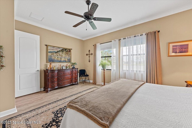 2889 Millennium Cir, Melbourne, FL 32940 - bedroom with wood finished floors, crown molding, baseboards, and a ceiling fan