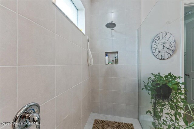 2889 Millennium Cir, Melbourne, FL 32940 - bathroom featuring a tile shower
