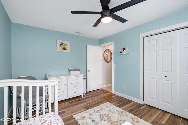 1035 Blau Ct NW, Palm Bay, FL 32907 - bedroom with a closet, dark wood-style flooring, baseboards, and a ceiling fan