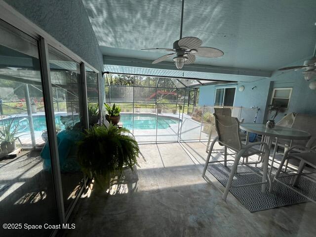 130 Nemo Cir NE, Palm Bay, FL 32907 - outdoor pool featuring a ceiling fan, a lanai, a patio, and outdoor dining space