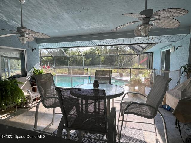 130 Nemo Cir NE, Palm Bay, FL 32907 - view of patio / terrace with ceiling fan, an outdoor pool, glass enclosure, and outdoor dining area