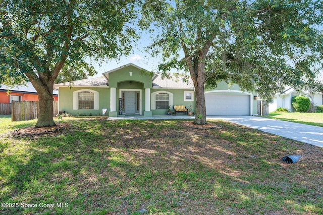 1317 Mohegan Ter SE, Palm Bay, FL 32909 - view of front of house with concrete driveway, stucco siding, and an attached garage