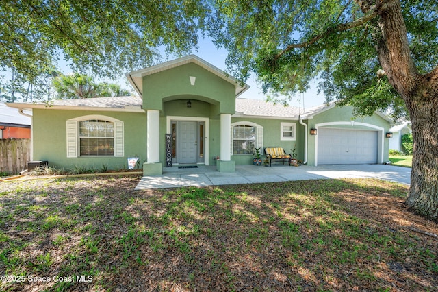1317 Mohegan Ter SE, Palm Bay, FL 32909 - view of front of house featuring stucco siding, an attached garage, driveway, and roof with shingles