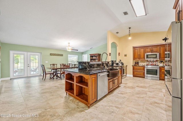 1317 Mohegan Ter SE, Palm Bay, FL 32909 - kitchen featuring stainless steel appliances, brown cabinets, open shelves, a sink, and vaulted ceiling