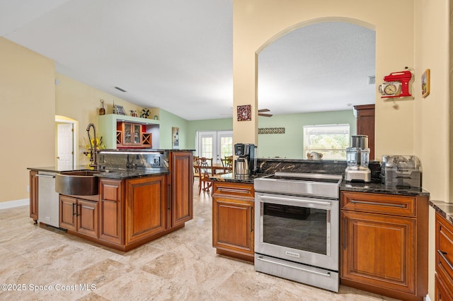 1317 Mohegan Ter SE, Palm Bay, FL 32909 - kitchen featuring stainless steel appliances, arched walkways, french doors, and brown cabinetry