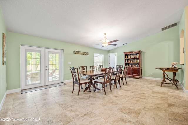 1317 Mohegan Ter SE, Palm Bay, FL 32909 - dining space with healthy amount of natural light, a ceiling fan, french doors, baseboards, and a textured ceiling